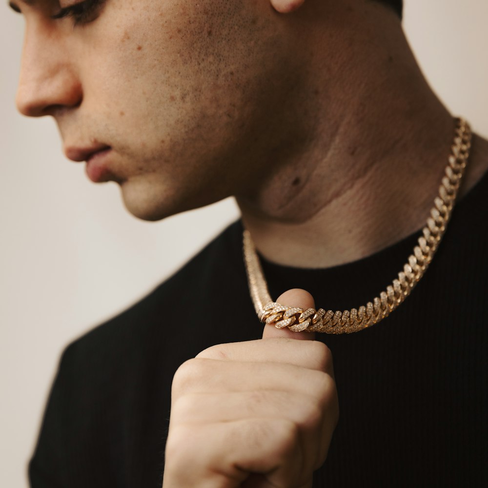 Close-up of a 14k gold Cuban link chain around the neck